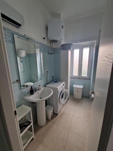 a bathroom with a sink and a washing machine at La Spiritiera in Minturno