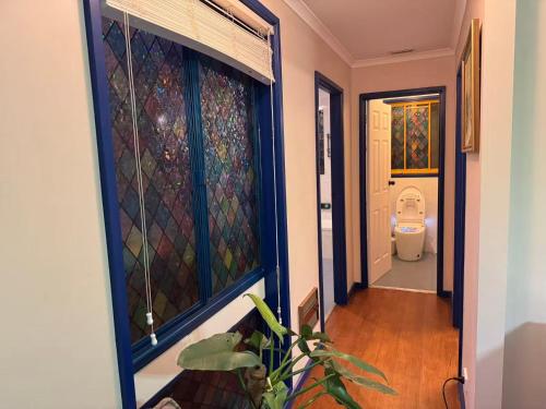 a hallway leading to a bathroom with a toilet at Sweet home in Goodwin Hill in Macgregor