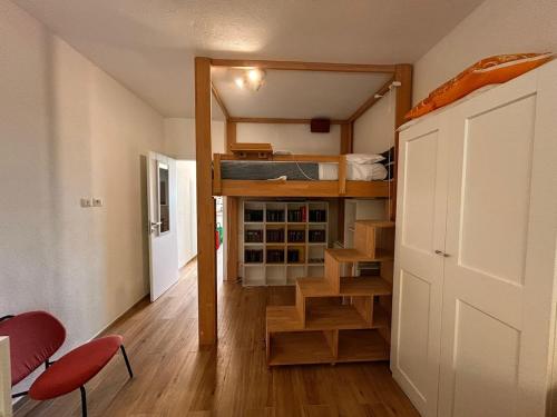 a small room with a bunk bed and stairs in it at Bilocale Is Molas Design, Giardino e Relax in Is Molas 