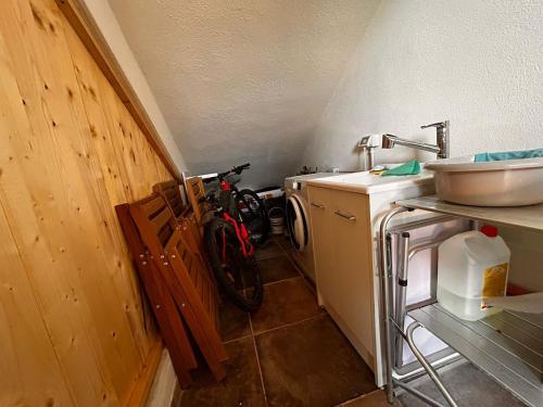 a bathroom with a sink and a bike in a room at Bilocale Is Molas Design, Giardino e Relax in Is Molas 