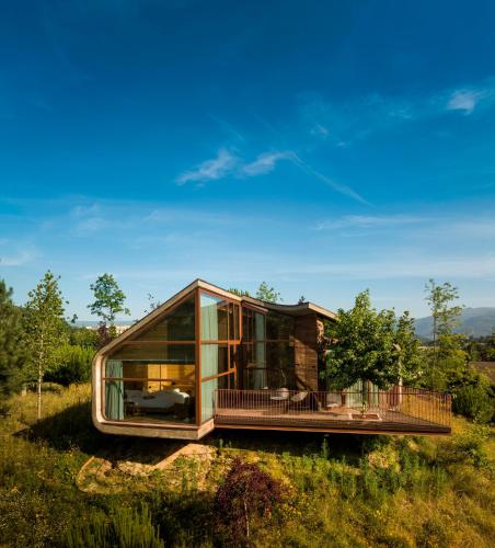 a glass house on a hill with a view at Lavandeira Douro Nature & Wellness in Baião