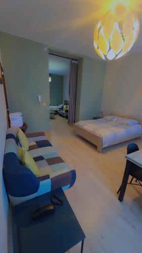 a room with a bed and a couch and a chair at Apartments Marco Polo Midi in Brussels