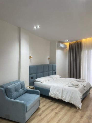 a bedroom with a large bed and a couch at Villa Mefaja in Krujë