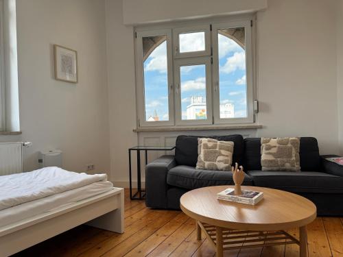 a living room with a couch and a table at Luxe Apartment am Rhein in Worms