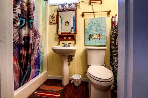 a small bathroom with a toilet and a sink at Cozy Cabin in Helen