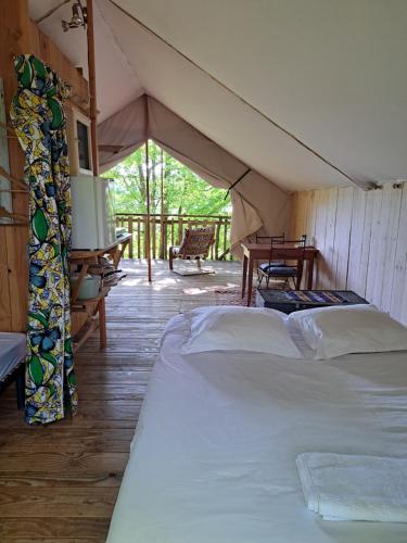 a room with two beds in a tent at Camping Terre Rouge in Villecomtal