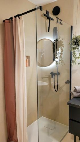 a shower with a glass door in a bathroom at Sunrise Apartment in Schladming