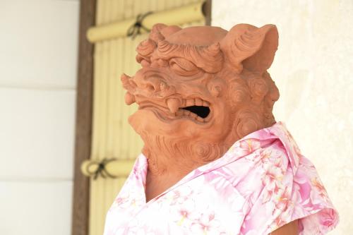 a statue of a person wearing a mask at Rakuchin in Naha