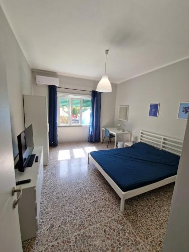 a bedroom with a bed and a desk and a television at La Spiritiera in Minturno
