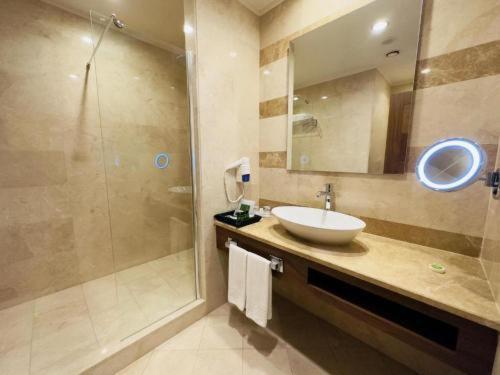a bathroom with a sink and a shower at Crixus Hotels Duhok in Duhok
