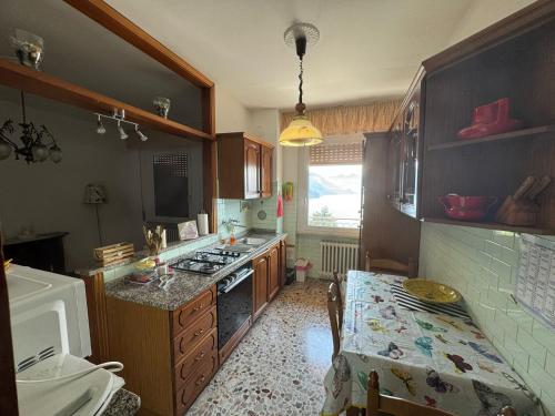 a kitchen with a sink and a stove top oven at Casa Claudia in Riva di Solto