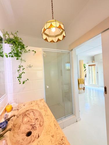 a bathroom with a sink and a glass shower at Rijke Rust, Living the Lagoon Life in Langebaan