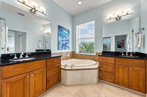 a bathroom with a tub and a sink at Admirals Watch - 673 in Siesta Key