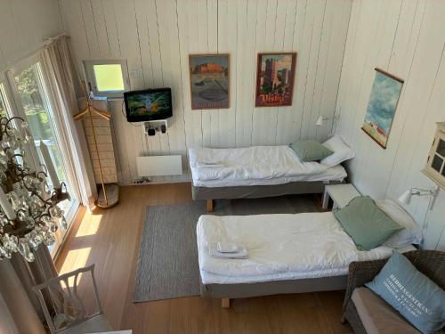 an overhead view of a room with two beds and a television at Strandboende in Beddinge Strand