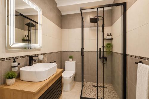 a bathroom with a sink and a shower at Apartmani Centar in Igalo