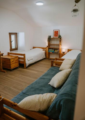 a bedroom with two beds with pillows on the floor at Hiša Potoki in Kobarid