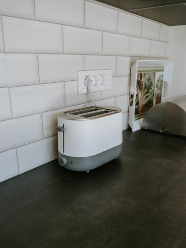 a toaster sitting on the floor in a room at Hiša Potoki in Kobarid