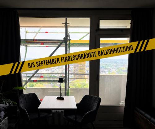 a yellow tape in front of a window with a table at Themenpartment Penthouse in Gelsenkirchen
