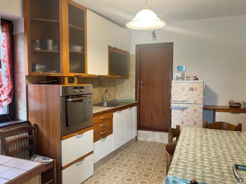 a small kitchen with a table and a refrigerator at Martin in Trento
