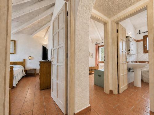 a bedroom with a bed and a bathroom with a sink at Sea View Three-Bedroom House 50m from the Beach in Baja Sardinia