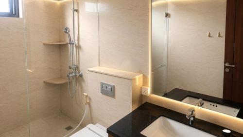 a bathroom with a shower and a toilet and a sink at SleepRest @ Nagoya Valley in Nagoya