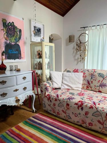a living room with a couch and a dresser at Casa do Paço Aveiro - HolidayHome in Aveiro