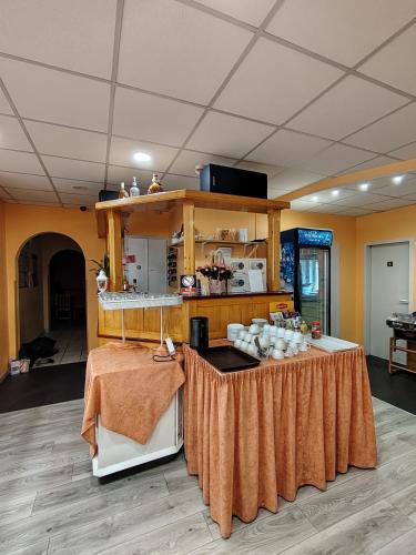 a room with a table with a counter with food on it at City Hotel Siófok in Siófok
