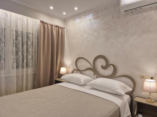 a bedroom with a bed with two white pillows at Nektaria on the Beach in Fournoi