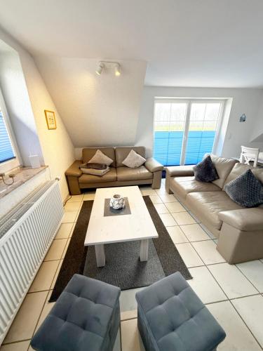 a living room with a couch and a table at Strandgut in Fehmarn