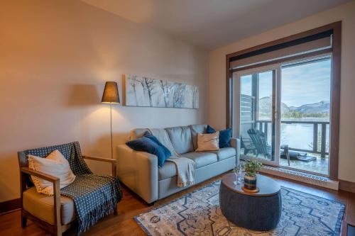 a living room with a couch and a chair at Condo overlooking Lac Superieur & mountain views in Lac-Superieur