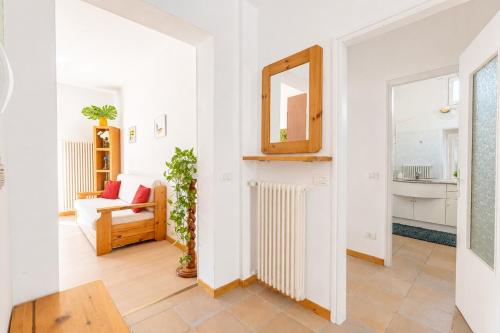 a living room with a mirror and a radiator at Giardino del Convento in Domaso