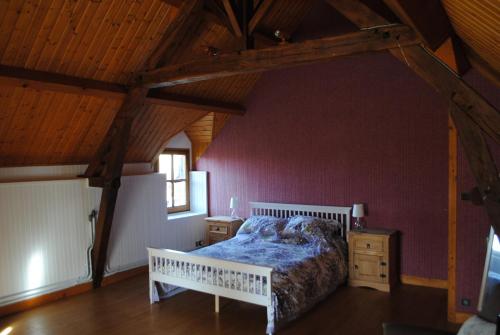 a bedroom with a bed and a wooden ceiling at Lakeview Family Fishing Gite in Roussines