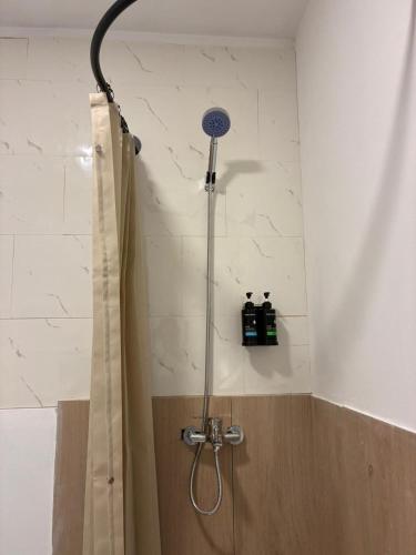 a shower with a shower head in a bathroom at La casa de la abuela in Narón
