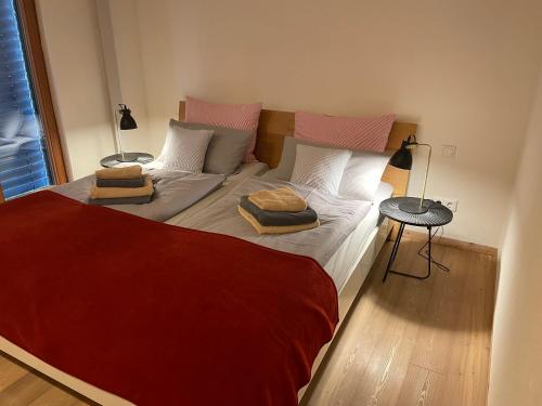a bedroom with a bed with two pillows on it at Sonnenchalet in Bodman-Ludwigshafen