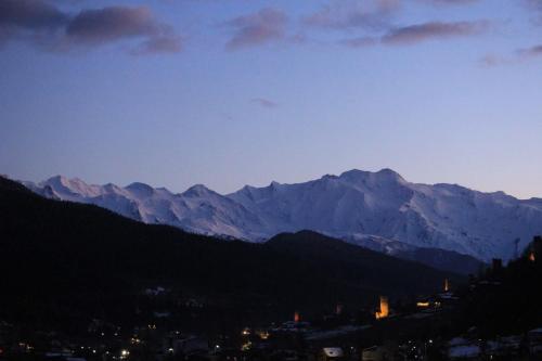 a view of a city with mountains in the background at Ninama in Mestia