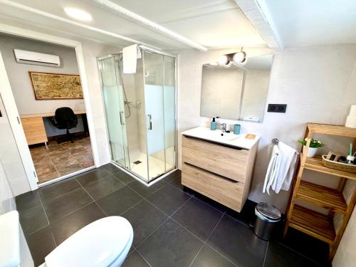 a bathroom with a toilet and a sink and a shower at Mas de la Maria in Cambrils