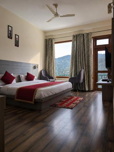 a bedroom with a bed and a large window at pristine mountain lodge in Chail