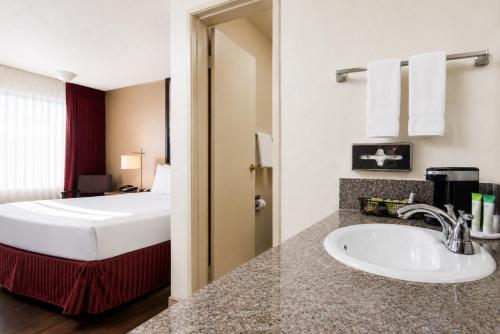 a bathroom with a sink in a hotel room at Kings Inn Anaheim at The Park & Convention Center in Anaheim