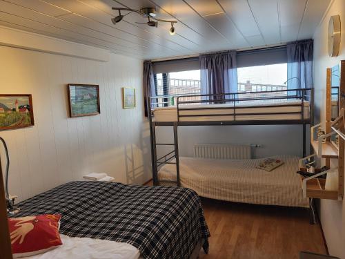 a bedroom with two bunk beds and a window at Holiday Guesthouse in Stykkishólmur