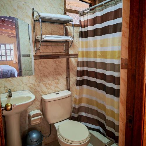 a bathroom with a toilet and a sink at Sunshine in Ollantaytambo