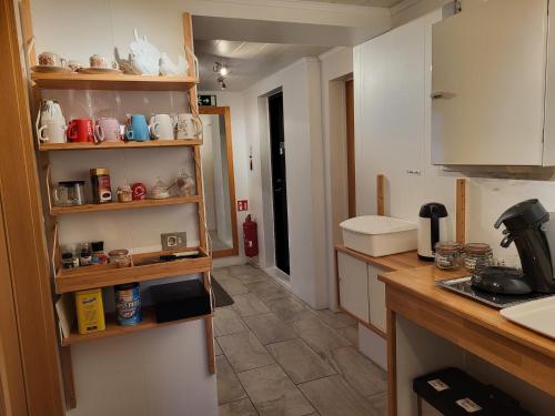 a kitchen with white cabinets and a counter top at Holiday Guesthouse in Stykkishólmur