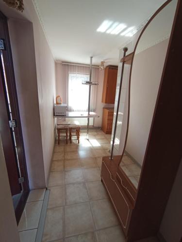 a room with a hallway with a table and a mirror at Котедж - Prestige in Vorokhta