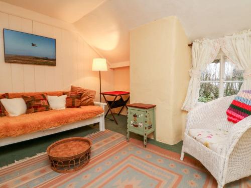 a living room with a couch and a table at Whitefield Cottage in Barnstaple
