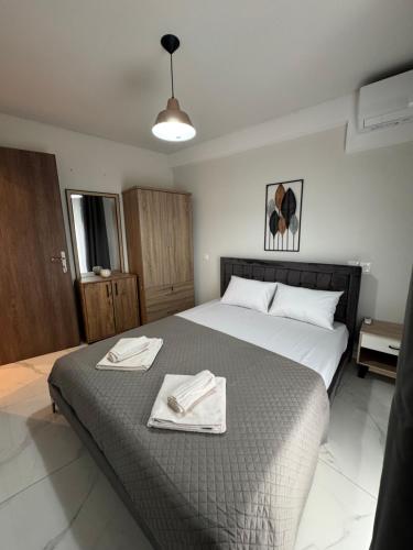 a bedroom with a bed with two towels on it at Studio AZOTI in Kástron