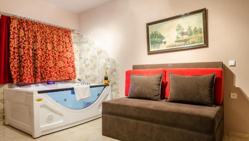 a living room with a couch and a fish tank at Hotel Athina in Kato Loutraki