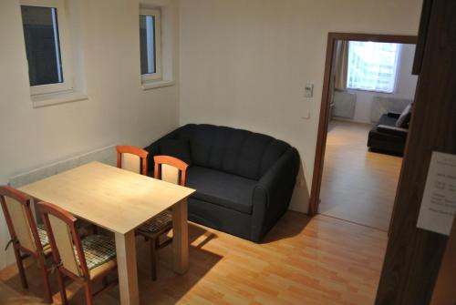 a living room with a couch and a table at Buranka Apartment in Jablonec nad Jizerou