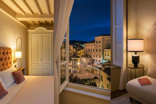 a room with a window with a view of a city at Ginevra Suite in Cortona