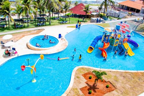 a group of people in a pool at a water park at El Aram Imirá Beach Resort in Natal