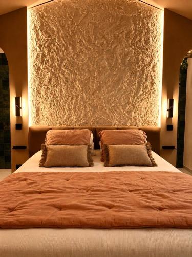 a bedroom with a large bed with two pillows at La Casita Rosa in Valras-Plage