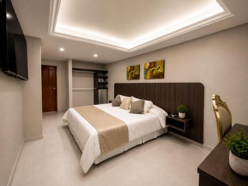 a bedroom with a large bed and a television at Fontamar 43 in Barranquilla